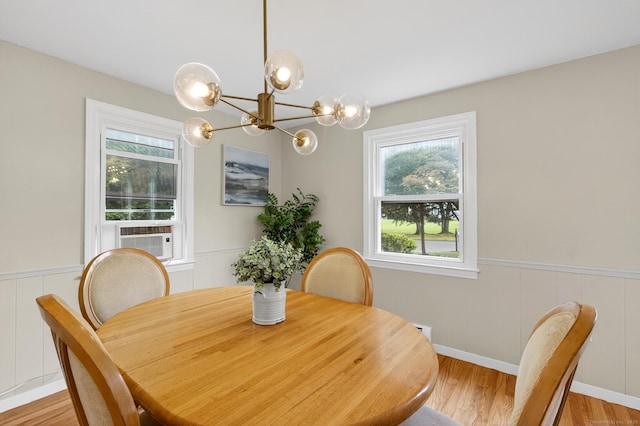 29 Bradford Dr, Windsor, CT 06095 - dining area with cooling unit, light wood-style floors, a chandelier, wainscoting, and a decorative wall