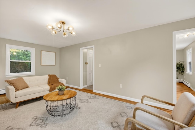 29 Bradford Dr, Windsor, CT 06095 - living room with a chandelier, light wood finished floors, and baseboard heating
