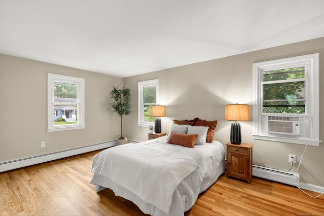 29 Bradford Dr, Windsor, CT 06095 - bedroom with baseboard heating, light wood-type flooring, and cooling unit