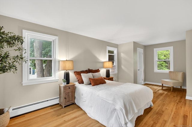 29 Bradford Dr, Windsor, CT 06095 - bedroom with a baseboard heating unit and light wood finished floors