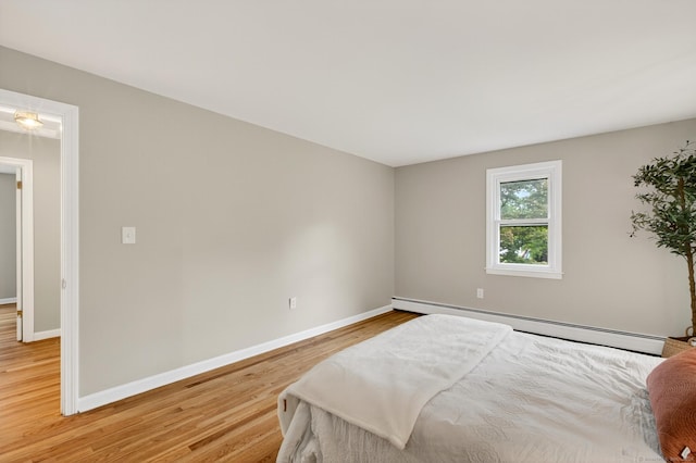 29 Bradford Dr, Windsor, CT 06095 - bedroom with a baseboard radiator and light wood-style floors
