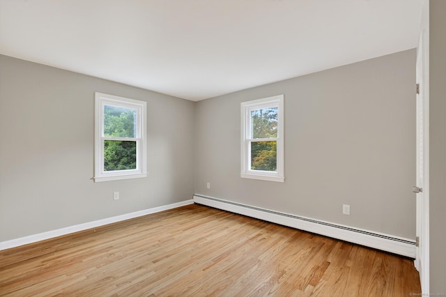 29 Bradford Dr, Windsor, CT 06095 - empty room with baseboard heating, wood finished floors, and healthy amount of natural light