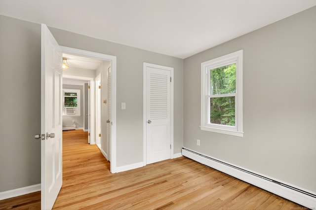 29 Bradford Dr, Windsor, CT 06095 - unfurnished bedroom featuring a baseboard heating unit, light wood-type flooring, and a closet