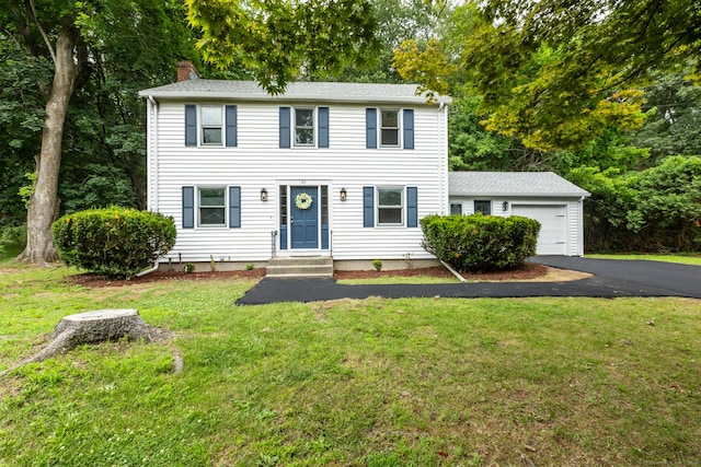 29 Bradford Dr, Windsor, CT 06095 - colonial inspired home featuring an attached garage, a chimney, asphalt driveway, and a front yard
