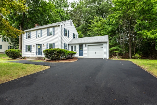 29 Bradford Dr, Windsor, CT 06095 - colonial house featuring driveway, a garage, a chimney, view of scattered trees, and a front lawn
