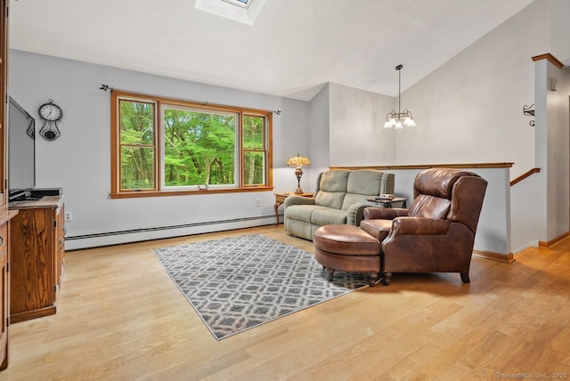 44 Brindlewood Path, Colchester, CT 06415 - living area with a baseboard radiator, a chandelier, light wood-style flooring, a skylight, and high vaulted ceiling