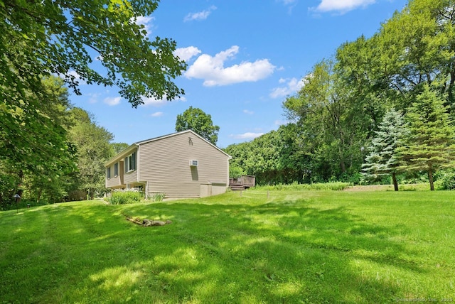 44 Brindlewood Path, Colchester, CT 06415 - view of green lawn with a forest view and a wooden deck