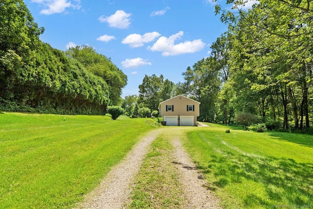 44 Brindlewood Path, Colchester, CT 06415 - view of green lawn featuring driveway and an attached garage