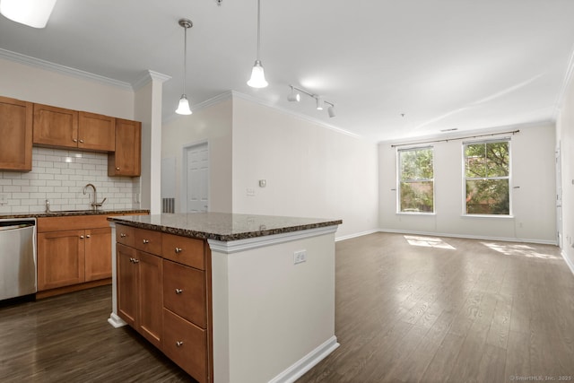 25 Adams Ave Unit 103, Stamford, CT 06902 - kitchen featuring stainless steel dishwasher, dark wood finished floors, ornamental molding, decorative backsplash, and a center island