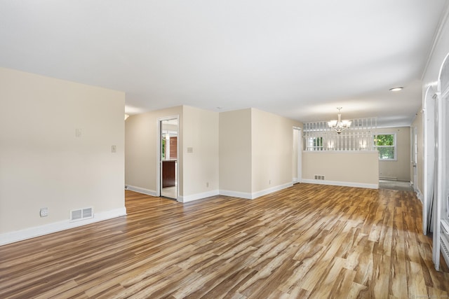 253 Simsbury Rd, West Hartford, CT 06117 - unfurnished living room featuring light wood-style flooring and a chandelier