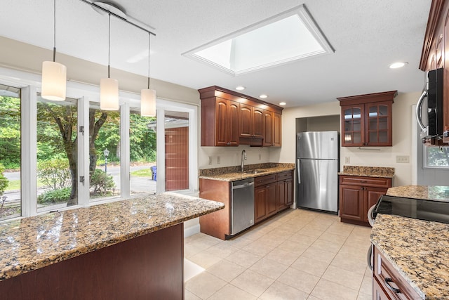 253 Simsbury Rd, West Hartford, CT 06117 - kitchen with stainless steel appliances, glass insert cabinets, light stone countertops, decorative light fixtures, and light tile patterned floors