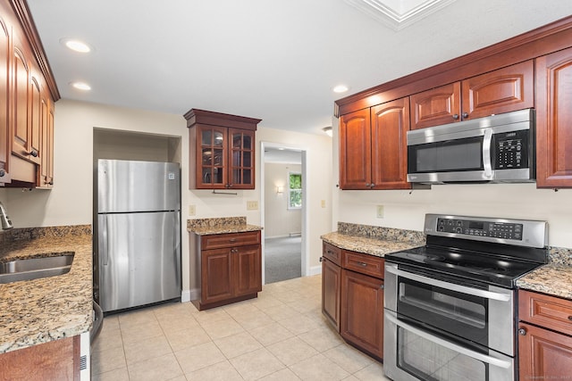 253 Simsbury Rd, West Hartford, CT 06117 - kitchen with stainless steel appliances, recessed lighting, glass insert cabinets, light stone counters, and light tile patterned flooring