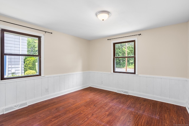 253 Simsbury Rd, West Hartford, CT 06117 - spare room with wood finished floors and a wainscoted wall