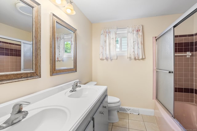 253 Simsbury Rd, West Hartford, CT 06117 - bathroom with tile patterned floors, plenty of natural light, double vanity, and combined bath / shower with glass door