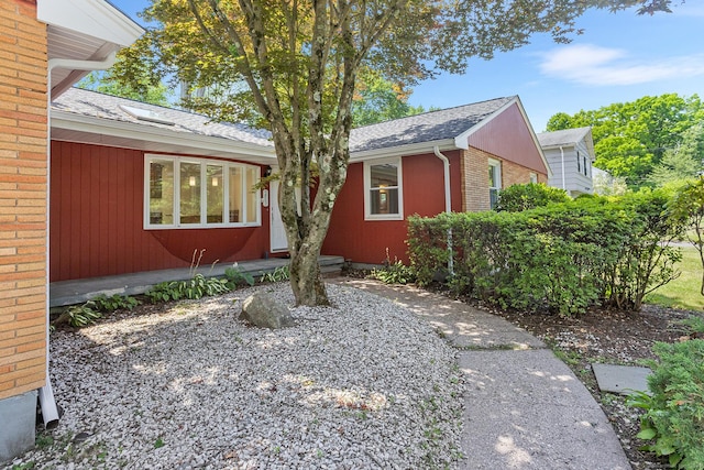 253 Simsbury Rd, West Hartford, CT 06117 - view of front of home with brick siding and roof with shingles