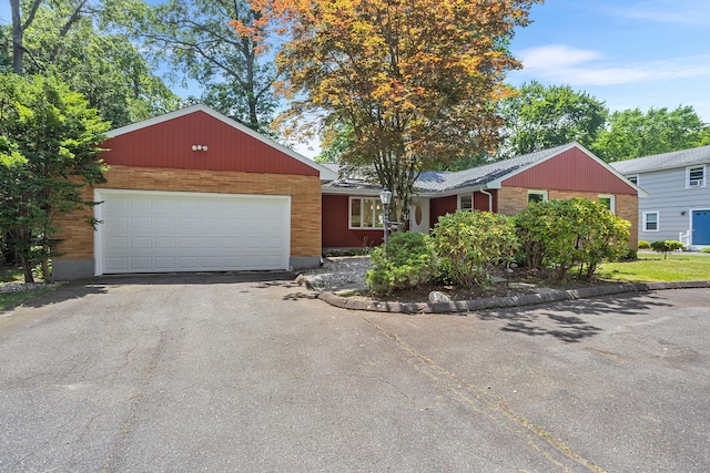 253 Simsbury Rd, West Hartford, CT 06117 - ranch-style home featuring asphalt driveway, an attached garage, and brick siding