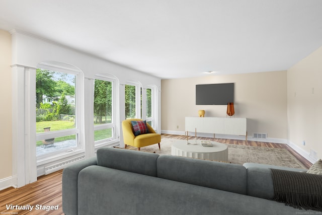 253 Simsbury Rd, West Hartford, CT 06117 - living area with plenty of natural light, baseboard heating, and wood finished floors