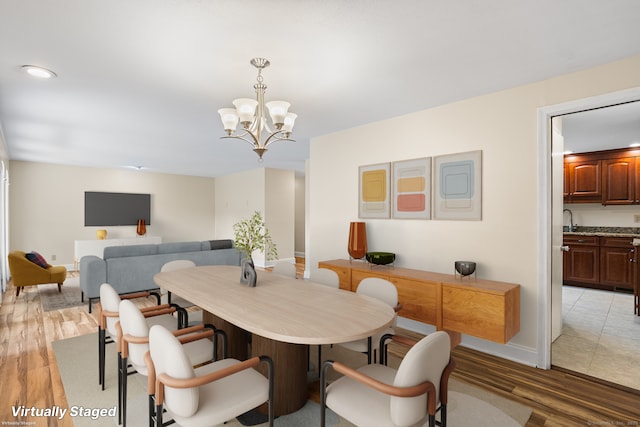 253 Simsbury Rd, West Hartford, CT 06117 - dining space with a chandelier and light wood-style floors