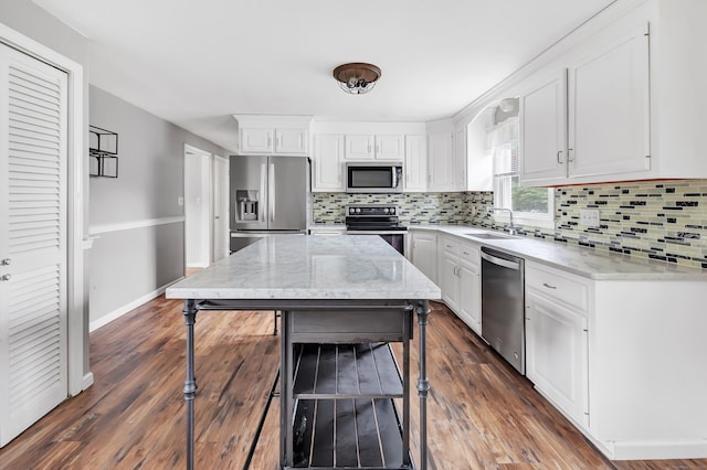66 Bridgeport Ave, Bristol, CT 06010 - kitchen with appliances with stainless steel finishes, white cabinetry, backsplash, and light stone counters