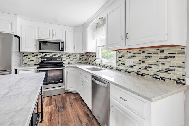 66 Bridgeport Ave, Bristol, CT 06010 - kitchen with appliances with stainless steel finishes, backsplash, white cabinets, and dark wood-style flooring
