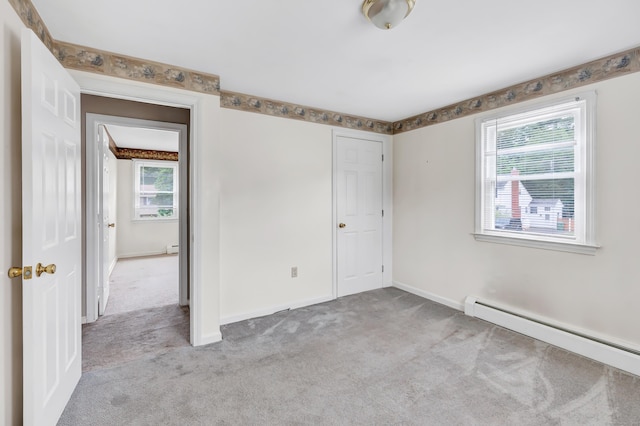 66 Bridgeport Ave, Bristol, CT 06010 - unfurnished bedroom with a baseboard radiator, light colored carpet, and a baseboard heating unit