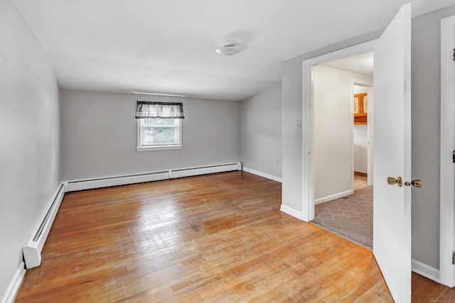 66 Bridgeport Ave, Bristol, CT 06010 - spare room with wood finished floors, baseboard heating, and a smoke detector
