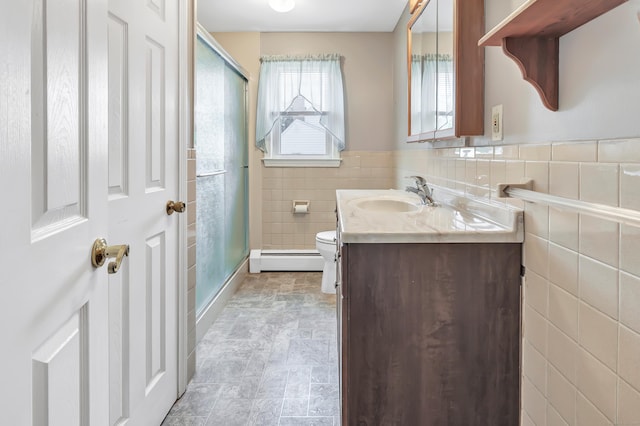 66 Bridgeport Ave, Bristol, CT 06010 - bathroom with a baseboard heating unit, a stall shower, vanity, and tile walls