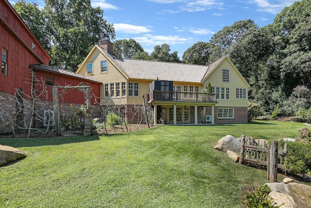 44 Brook St, Groton, CT 06340 - back of property with a chimney, a yard, french doors, and stone siding