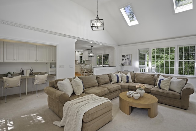 70 Fitch Ln, New Canaan, CT 06840 - living room with high vaulted ceiling, a skylight, a chandelier, light colored carpet, and plenty of natural light
