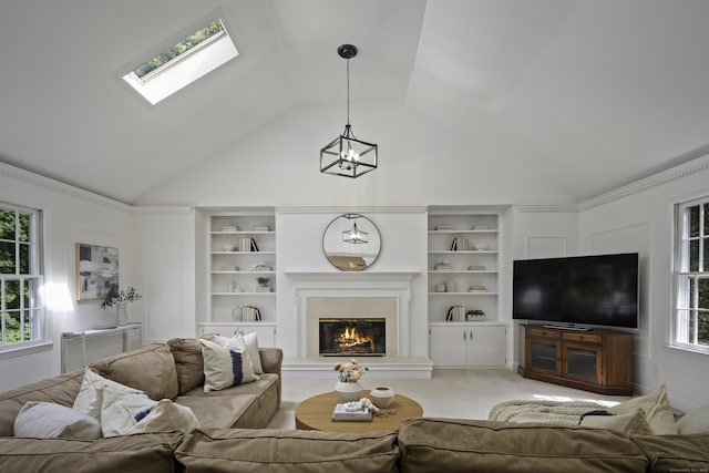 70 Fitch Ln, New Canaan, CT 06840 - living room with a glass covered fireplace, a chandelier, built in features, a skylight, and high vaulted ceiling