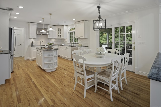 70 Fitch Ln, New Canaan, CT 06840 - dining area with healthy amount of natural light, light wood finished floors, a chandelier, recessed lighting, and crown molding