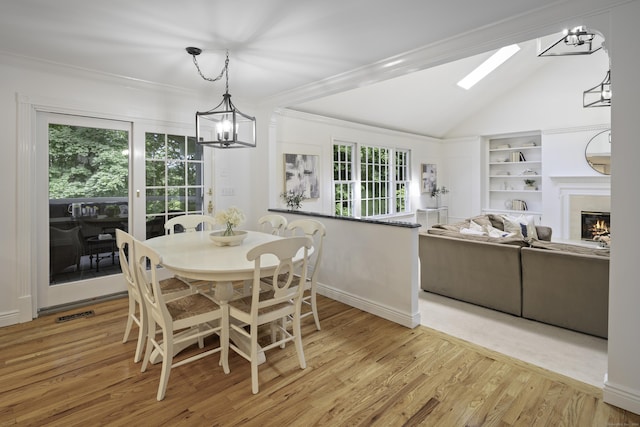 70 Fitch Ln, New Canaan, CT 06840 - dining room with a chandelier, lofted ceiling, wood finished floors, ornamental molding, and built in features