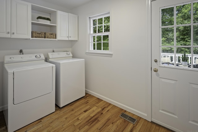 70 Fitch Ln, New Canaan, CT 06840 - laundry area featuring cabinet space, washer and clothes dryer, and light wood-type flooring