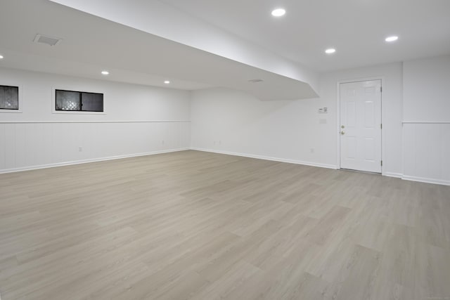 70 Fitch Ln, New Canaan, CT 06840 - finished below grade area featuring light wood-type flooring, a wainscoted wall, recessed lighting, and a decorative wall