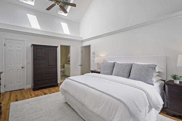 70 Fitch Ln, New Canaan, CT 06840 - bedroom featuring high vaulted ceiling, a skylight, light wood-style floors, ensuite bath, and a ceiling fan