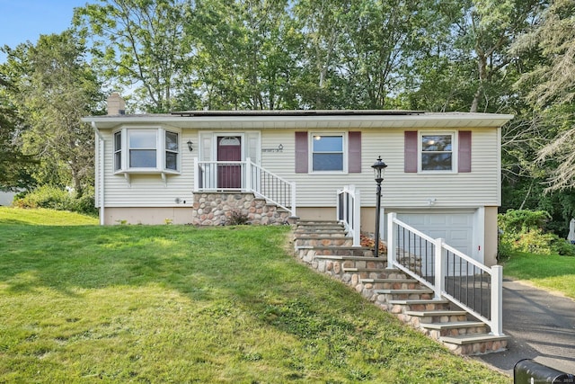 8 Rain Dance Cir, Naugatuck, CT 06770 - view of front of house featuring a garage, a chimney, asphalt driveway, and a front lawn