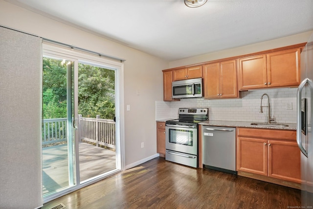 8 Rain Dance Cir, Naugatuck, CT 06770 - kitchen with appliances with stainless steel finishes, light stone countertops, backsplash, and dark wood-style floors