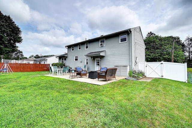 16 Kenwood Rd, Meriden, CT 06450 - back of property with a patio, a fenced backyard, and a gate