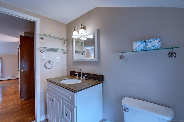 16 Kenwood Rd, Meriden, CT 06450 - bathroom with vanity, a baseboard heating unit, wood finished floors, and vaulted ceiling
