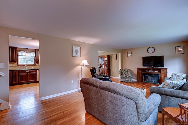 16 Kenwood Rd, Meriden, CT 06450 - living room with light wood-type flooring and a glass covered fireplace