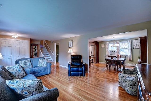 16 Kenwood Rd, Meriden, CT 06450 - living area with a chandelier, stairs, baseboard heating, and light wood-type flooring