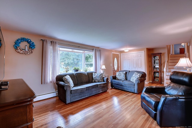 16 Kenwood Rd, Meriden, CT 06450 - living room featuring baseboard heating, light wood-type flooring, and stairs
