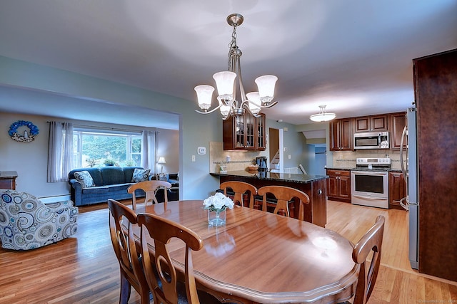 16 Kenwood Rd, Meriden, CT 06450 - dining space featuring light wood-style flooring, a chandelier, and a baseboard radiator