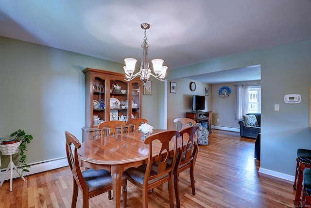 16 Kenwood Rd, Meriden, CT 06450 - dining area with a baseboard heating unit, a chandelier, and light wood-style flooring