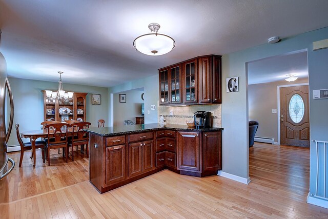 16 Kenwood Rd, Meriden, CT 06450 - kitchen featuring baseboard heating, light wood-style flooring, a chandelier, a peninsula, and tasteful backsplash