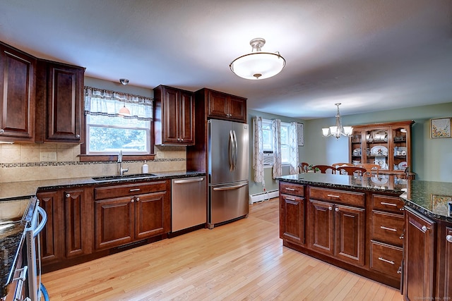 16 Kenwood Rd, Meriden, CT 06450 - kitchen featuring appliances with stainless steel finishes, a baseboard heating unit, a chandelier, light wood finished floors, and backsplash
