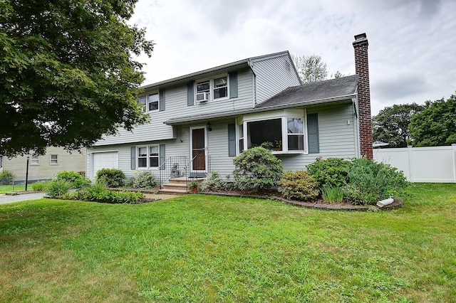 16 Kenwood Rd, Meriden, CT 06450 - tri-level home featuring a chimney and a garage