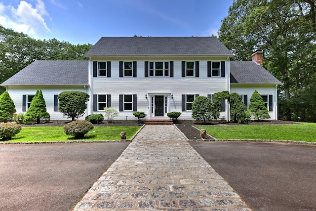 330 Webb Cir, Monroe, CT 06468 - colonial home with a chimney, roof with shingles, and a front yard