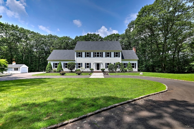 330 Webb Cir, Monroe, CT 06468 - colonial inspired home featuring curved driveway, a chimney, an outdoor structure, and a front yard