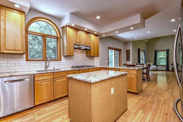330 Webb Cir, Monroe, CT 06468 - kitchen featuring appliances with stainless steel finishes, a peninsula, under cabinet range hood, light stone counters, and a center island